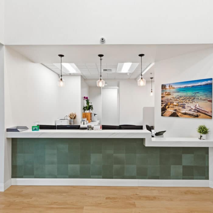 Reception desk with a green tiled front