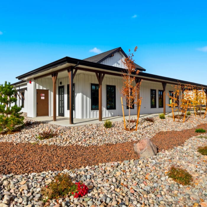 The office with its covered porch and rock garden