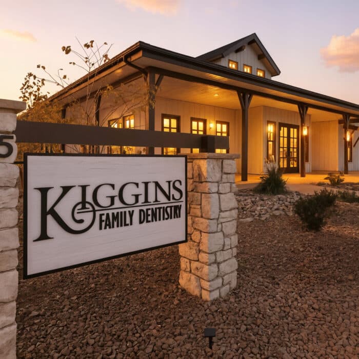 Kiggins Family Dentistry sign in front of the office at dusk